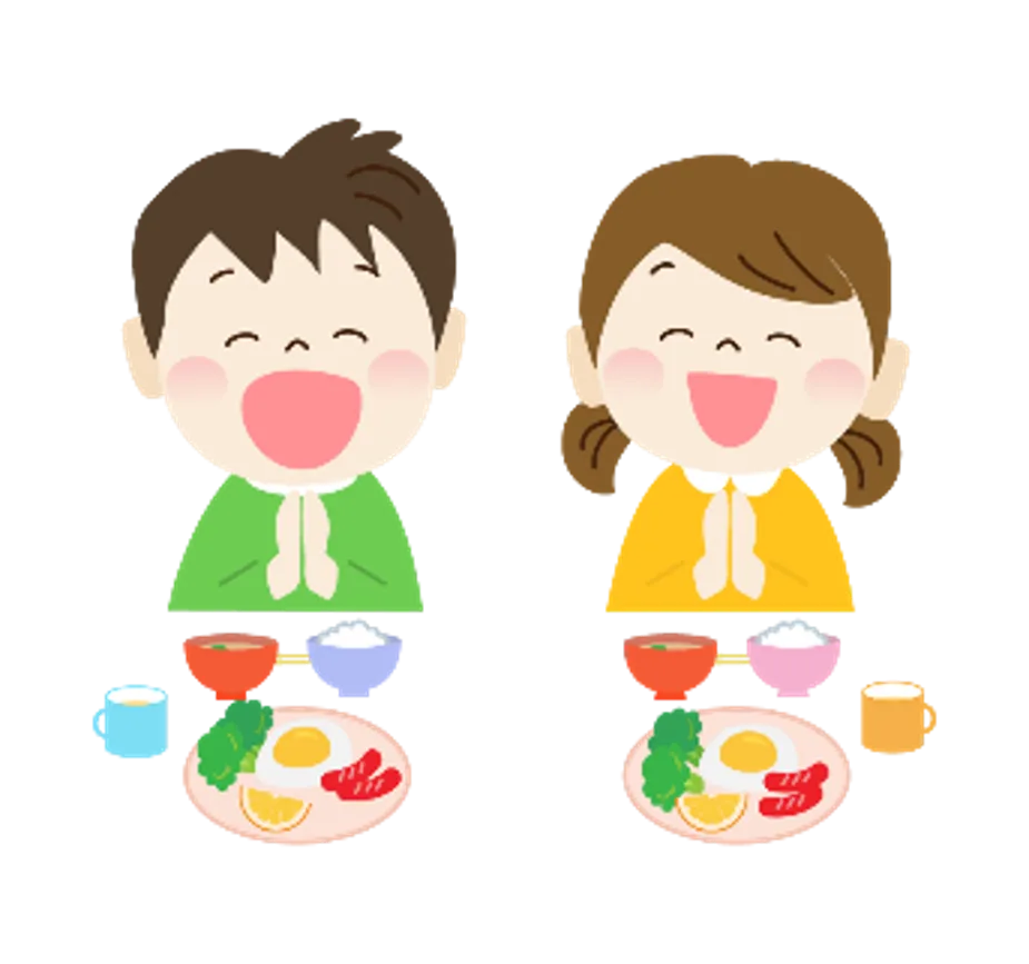 Two children bowing with hands in prayer before a meal at the table with plates and drinks behind them